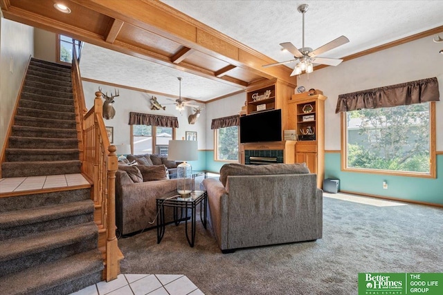 754 10th St, Syracuse, NE 68446 - carpeted living area featuring ceiling fan, ornamental molding, stairs, a tile fireplace, and coffered ceiling