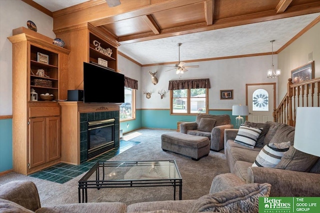 754 10th St, Syracuse, NE 68446 - living room with carpet floors, a tiled fireplace, ornamental molding, ceiling fan, and a chandelier