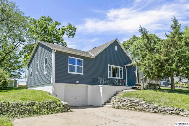 2705 Margo St, Bellevue, NE 68147 - view of front of house featuring a garage, a front yard, and driveway