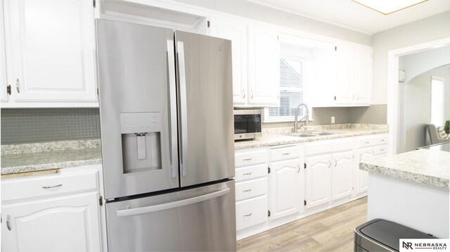 1757 N Linden St, Wahoo, NE 68066 - kitchen featuring appliances with stainless steel finishes, tasteful backsplash, and white cabinets