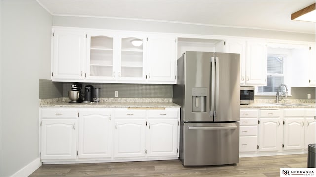 1757 N Linden St, Wahoo, NE 68066 - kitchen featuring stainless steel fridge with ice dispenser, white cabinets, tasteful backsplash, light countertops, and ornamental molding