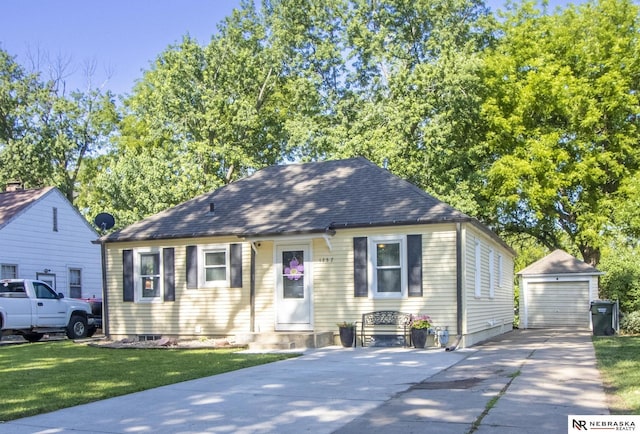 1757 N Linden St, Wahoo, NE 68066 - view of front facade with an outdoor structure, concrete driveway, a front yard, and a detached garage