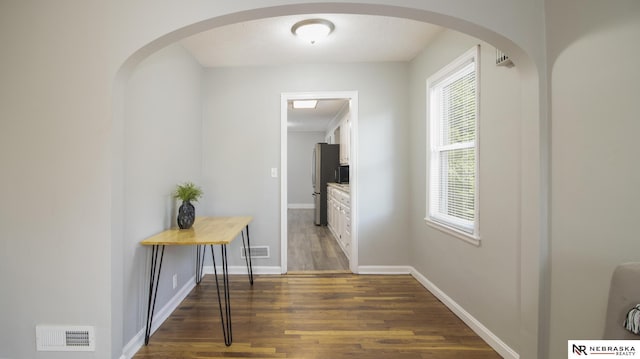 1757 N Linden St, Wahoo, NE 68066 - corridor with dark wood finished floors, plenty of natural light, and arched walkways