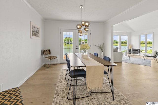 12328 Rose Ln, Omaha, NE 68154 - dining room featuring crown molding, a water view, light wood-type flooring, and a chandelier