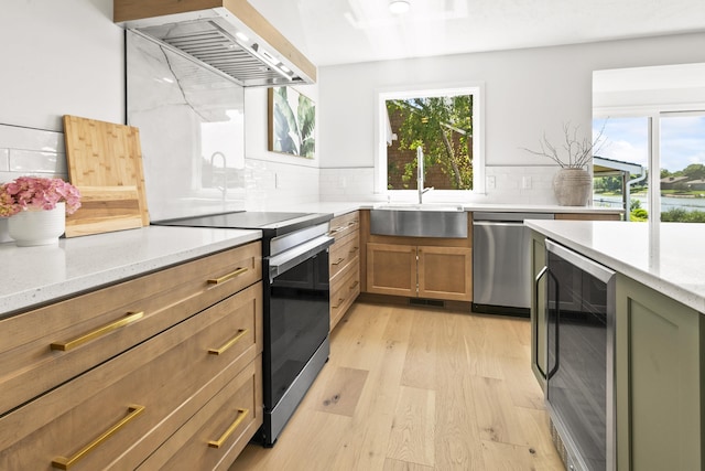 12328 Rose Ln, Omaha, NE 68154 - kitchen featuring stainless steel appliances, extractor fan, wine cooler, light wood-style floors, and decorative backsplash