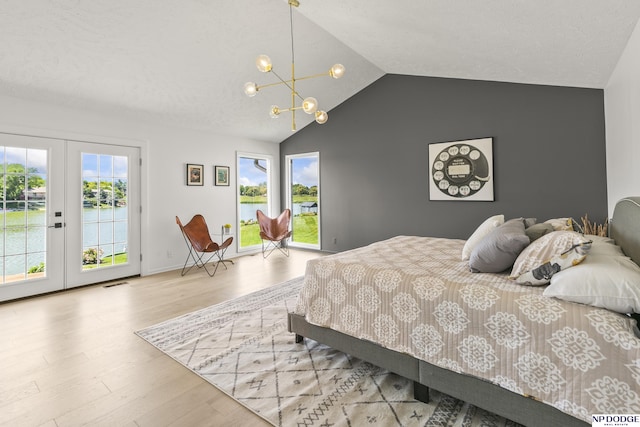12328 Rose Ln, Omaha, NE 68154 - bedroom featuring access to outside, lofted ceiling, french doors, wood finished floors, and a chandelier