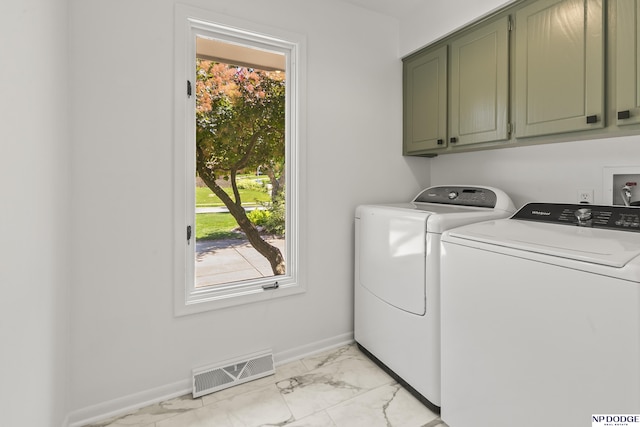 12328 Rose Ln, Omaha, NE 68154 - laundry room with cabinet space, washing machine and clothes dryer, and light marble finish floors