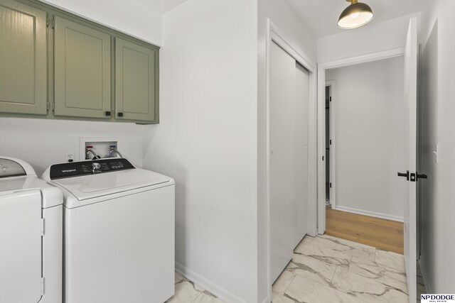 12328 Rose Ln, Omaha, NE 68154 - laundry area with cabinet space, independent washer and dryer, and light marble finish flooring