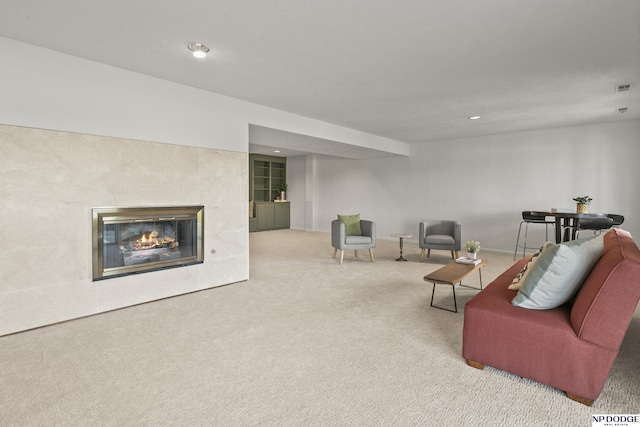 12328 Rose Ln, Omaha, NE 68154 - living room featuring carpet flooring, a tiled fireplace, and recessed lighting