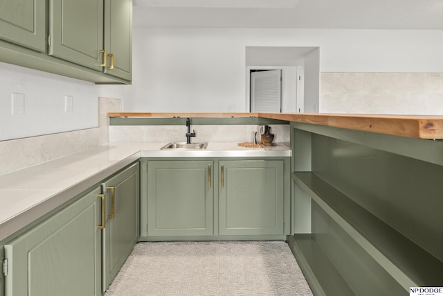 12328 Rose Ln, Omaha, NE 68154 - kitchen featuring green cabinets, light countertops, and light colored carpet