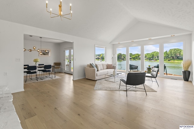 12328 Rose Ln, Omaha, NE 68154 - living room with a chandelier, vaulted ceiling, light wood-style flooring, french doors, and a water view