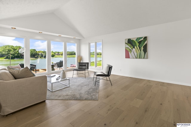 12328 Rose Ln, Omaha, NE 68154 - living area featuring a water view, wood finished floors, and high vaulted ceiling