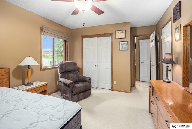 2219 Independence Dr, Lincoln, NE 68521 - bedroom with light colored carpet, a closet, and ceiling fan