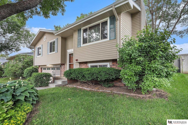 2219 Independence Dr, Lincoln, NE 68521 - split foyer home with an attached garage and a front yard