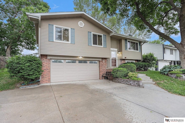 2219 Independence Dr, Lincoln, NE 68521 - raised ranch with brick siding, a garage, and driveway