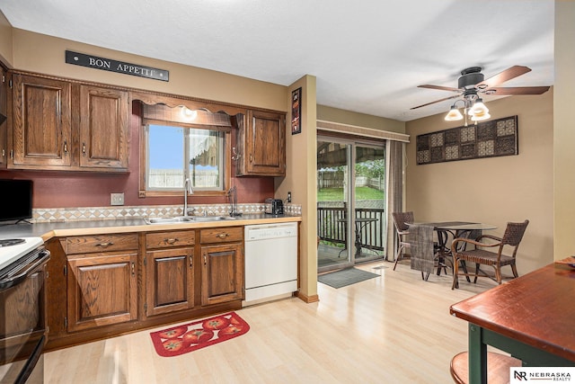 2219 Independence Dr, Lincoln, NE 68521 - kitchen featuring dishwasher, electric range, light wood-style floors, a ceiling fan, and light countertops