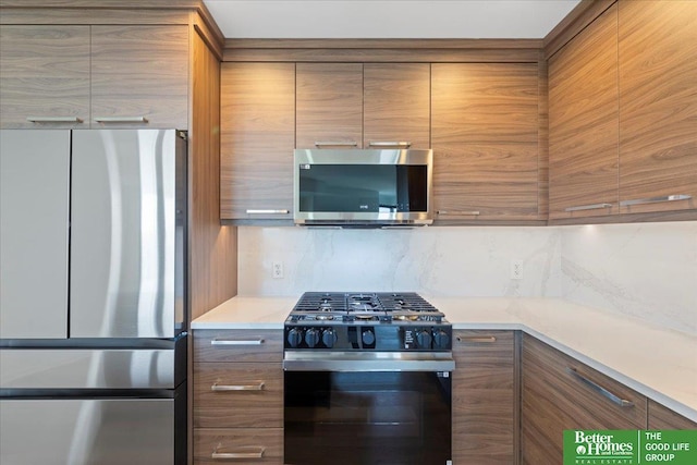 200 S 31st Ave Unit 4209, Omaha, NE 68131 - kitchen featuring appliances with stainless steel finishes, modern cabinets, light countertops, and brown cabinets