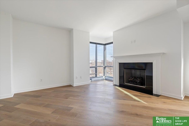200 S 31st Ave Unit 4209, Omaha, NE 68131 - unfurnished living room with a fireplace with flush hearth and wood finished floors