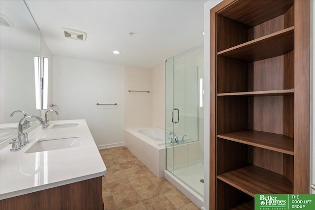 200 S 31st Ave Unit 4209, Omaha, NE 68131 - bathroom featuring a bath, double vanity, a stall shower, and recessed lighting