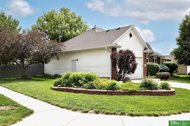 16140 Josephine St, Omaha, NE 68136 - view of side of home featuring a garage, concrete driveway, a shingled roof, and brick siding