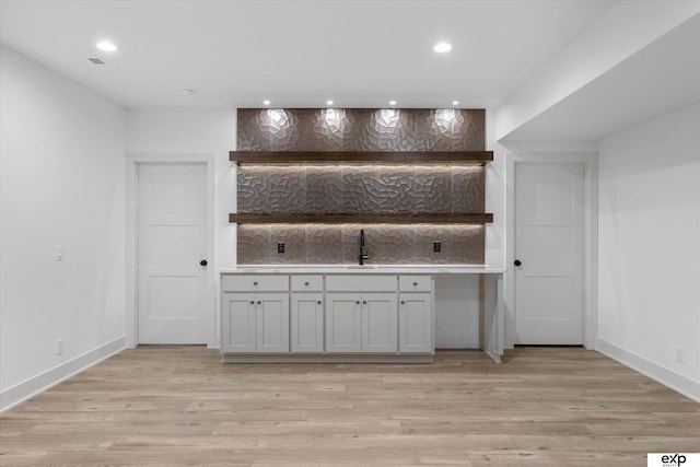 5516 N 208th Ave, Omaha, NE 68022 - bar with light wood finished floors, recessed lighting, and tasteful backsplash