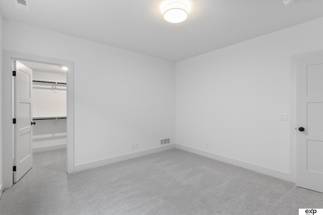 5516 N 208th Ave, Omaha, NE 68022 - unfurnished bedroom featuring light colored carpet, a spacious closet, and a closet