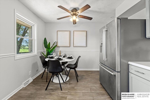301 Gladys Ave, Yutan, NE 68073 - dining room featuring ceiling fan, a textured ceiling, and wood finished floors