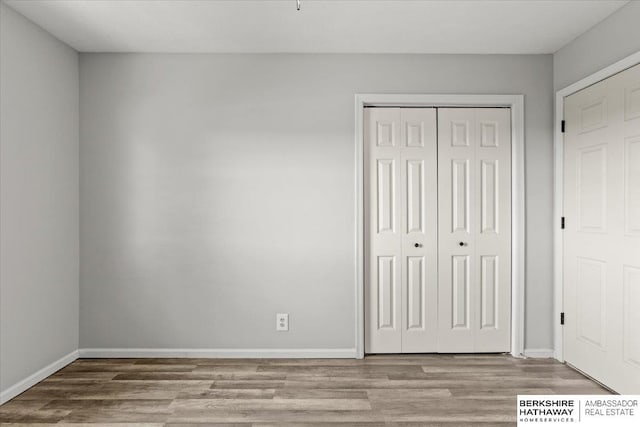 301 Gladys Ave, Yutan, NE 68073 - unfurnished bedroom with wood finished floors and a closet