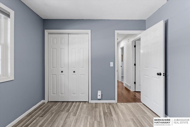 301 Gladys Ave, Yutan, NE 68073 - unfurnished bedroom featuring wood finished floors and a closet