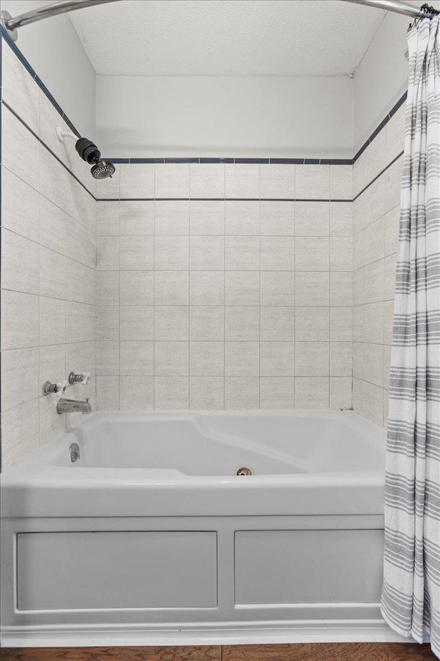 301 Gladys Ave, Yutan, NE 68073 - bathroom featuring shower / bath combo and a textured ceiling