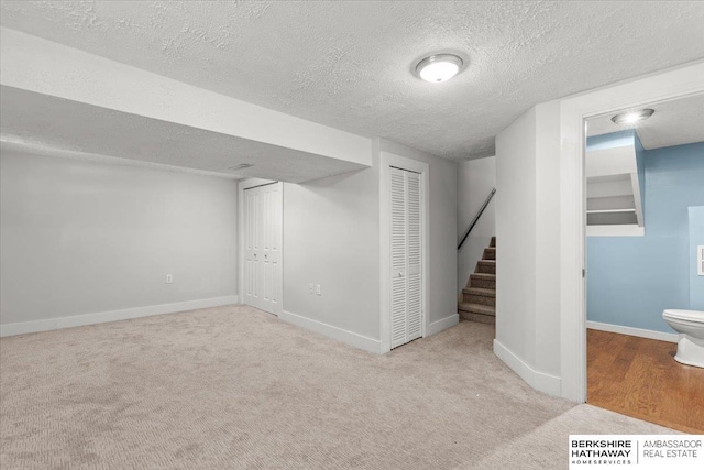 301 Gladys Ave, Yutan, NE 68073 - finished below grade area featuring carpet, a textured ceiling, and stairway