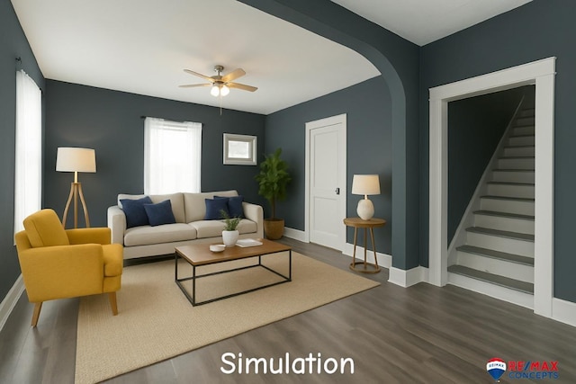 603 E Maple St, Sutton, NE 68979 - living room with a ceiling fan, wood finished floors, stairway, and arched walkways