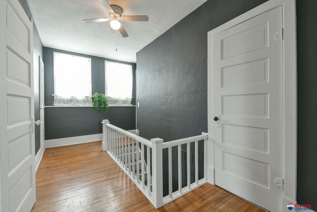 603 E Maple St, Sutton, NE 68979 - stairway featuring a ceiling fan and hardwood / wood-style floors