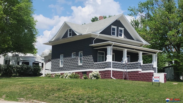 603 E Maple St, Sutton, NE 68979 - view of front of home with a porch, a front lawn, and a chimney