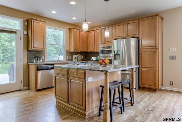 6732 S 169th Ave, Omaha, NE 68135 - kitchen featuring appliances with stainless steel finishes, a center island, healthy amount of natural light, light wood-style flooring, and recessed lighting