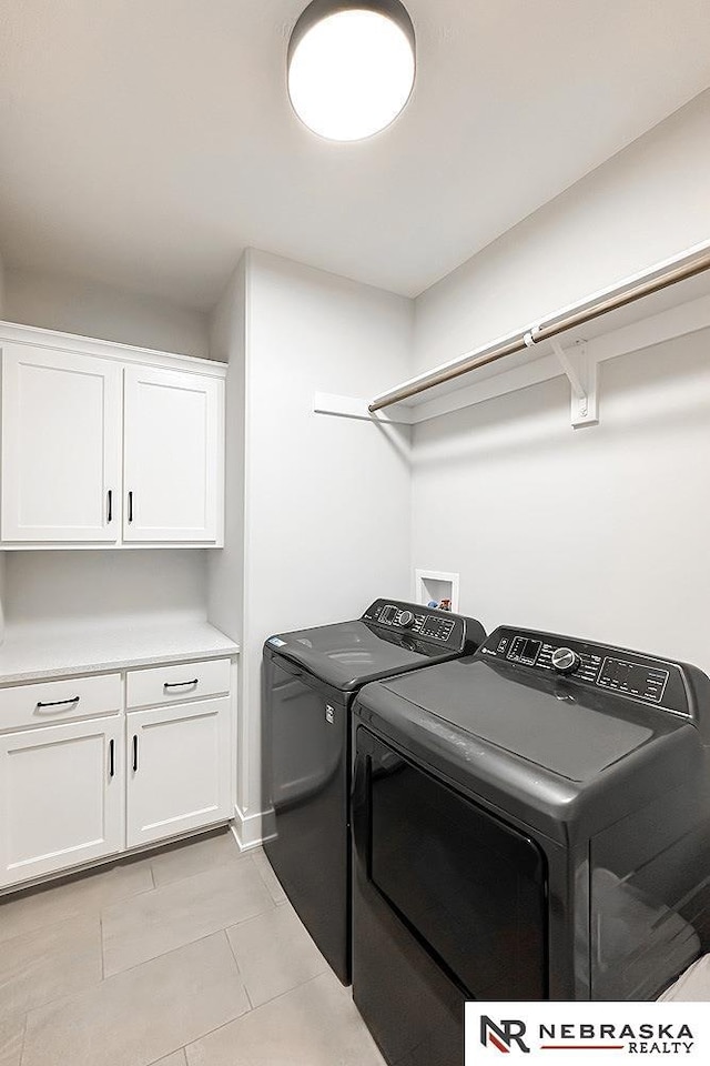 11701 S 119th Ave, Papillion, NE 68046 - laundry room featuring washer and dryer, cabinet space, and light tile patterned floors