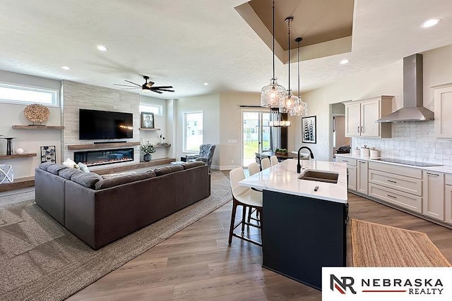 11701 S 119th Ave, Papillion, NE 68046 - kitchen with wall chimney range hood, open floor plan, black electric stovetop, recessed lighting, and light countertops