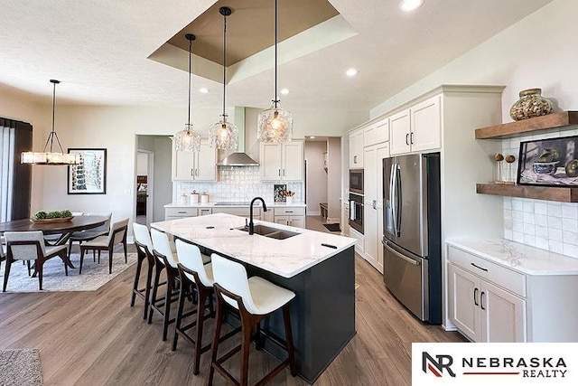 11701 S 119th Ave, Papillion, NE 68046 - kitchen featuring black appliances, wall chimney range hood, a center island with sink, dark wood-style floors, and tasteful backsplash