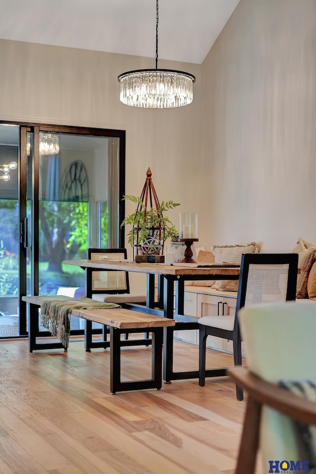 6833 Summerset Ct, Lincoln, NE 68516 - dining area with a chandelier, wood finished floors, and lofted ceiling