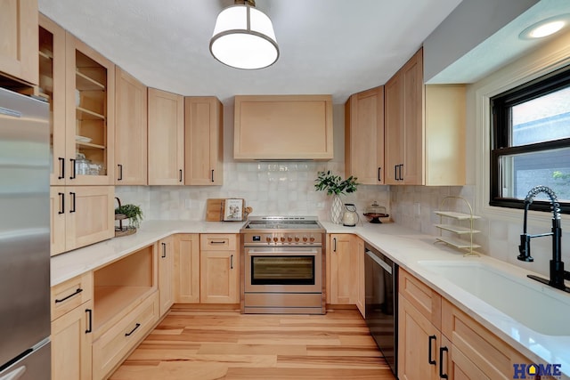 6833 Summerset Ct, Lincoln, NE 68516 - kitchen featuring high end appliances, light brown cabinetry, light wood-style flooring, and backsplash