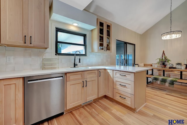 6833 Summerset Ct, Lincoln, NE 68516 - kitchen with stainless steel dishwasher, light brown cabinetry, a peninsula, a chandelier, and lofted ceiling