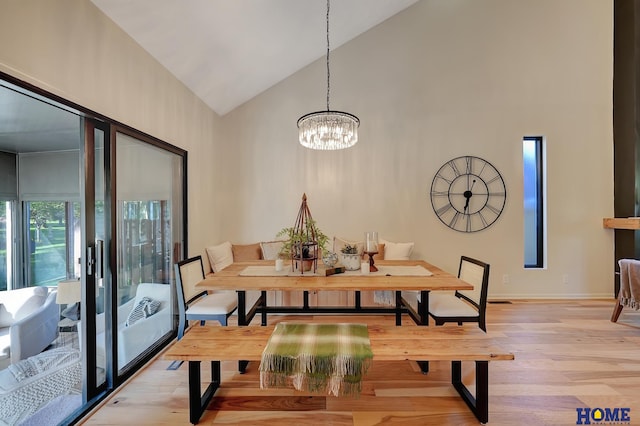6833 Summerset Ct, Lincoln, NE 68516 - dining area featuring high vaulted ceiling, light wood-style floors, and a chandelier