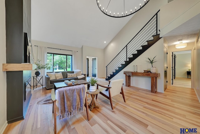 6833 Summerset Ct, Lincoln, NE 68516 - living area featuring high vaulted ceiling, stairway, light wood-style floors, and a chandelier