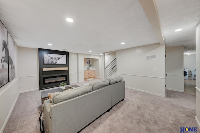 6833 Summerset Ct, Lincoln, NE 68516 - carpeted living room with recessed lighting, a large fireplace, stairs, and washer / dryer