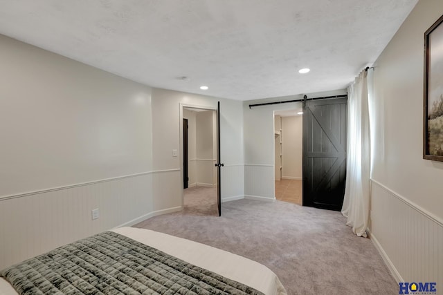 6833 Summerset Ct, Lincoln, NE 68516 - unfurnished bedroom featuring a barn door, a wainscoted wall, carpet, and recessed lighting