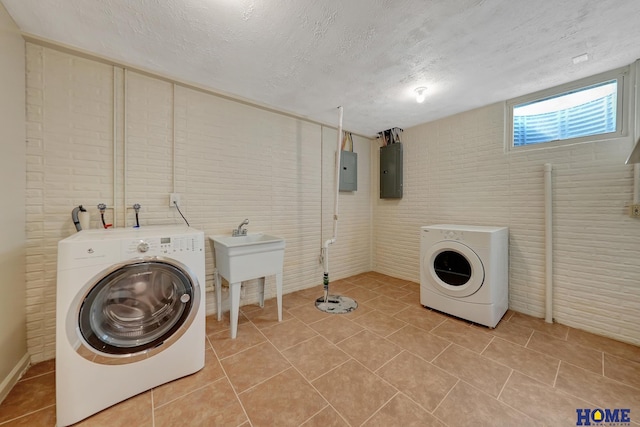 6833 Summerset Ct, Lincoln, NE 68516 - washroom with electric panel, washing machine and dryer, light tile patterned flooring, and a textured ceiling