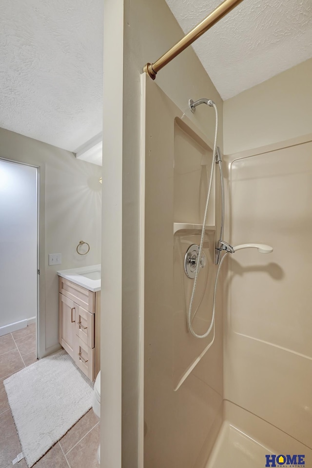 6833 Summerset Ct, Lincoln, NE 68516 - full bath featuring a textured ceiling, a stall shower, tile patterned flooring, and vanity