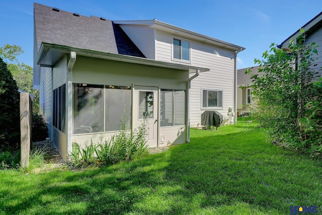 6833 Summerset Ct, Lincoln, NE 68516 - rear view of house with a sunroom, a lawn, and a shingled roof