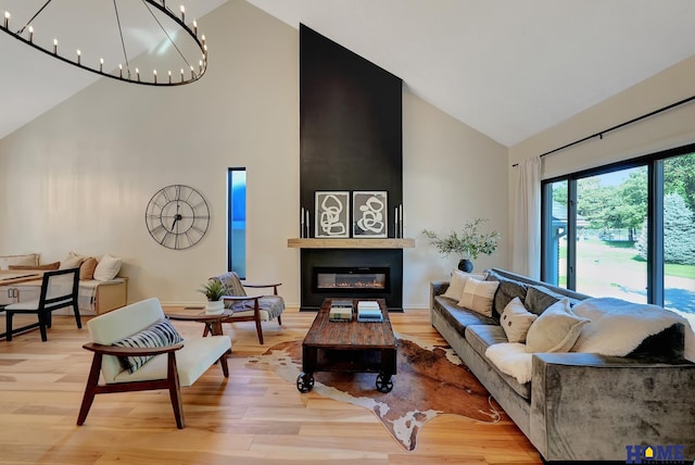 6833 Summerset Ct, Lincoln, NE 68516 - living area featuring high vaulted ceiling, wood finished floors, a chandelier, and a large fireplace