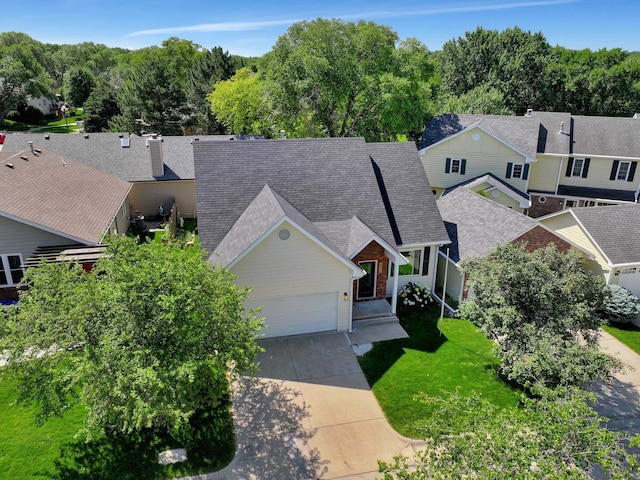 6833 Summerset Ct, Lincoln, NE 68516 - view of front facade featuring concrete driveway, a garage, a chimney, a shingled roof, and a front lawn